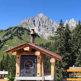 Forno a legna Clementi Master da incasso in ambiente montano — integrazione in struttura esterna
